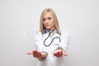 Young blonde doctor holding something in her hands