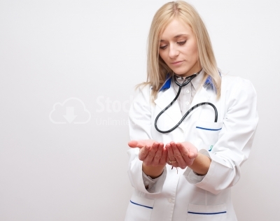 Young blonde doctor holding something in her hands