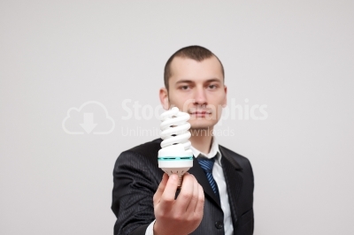 Young businessman holding a light bulb