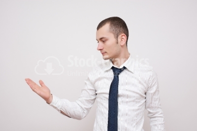 Young businessman looking at his hand