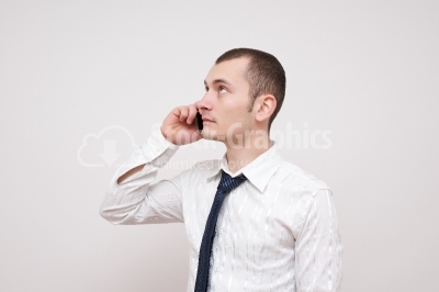 Young guy talking at the phone - Stock Image