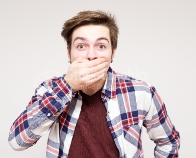 Young man covering his mouth