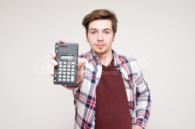 Young man holding a small calculator