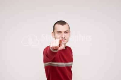 Young man pointing finger towards you and to the camera