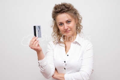 Young smiling business woman holding credit card isolated on whi