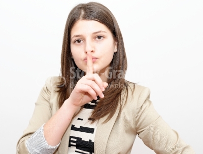 Young woman gesturing to be quiet