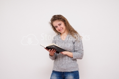 Young woman holding her datebook 