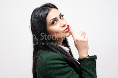 Young women gesturing to be quiet